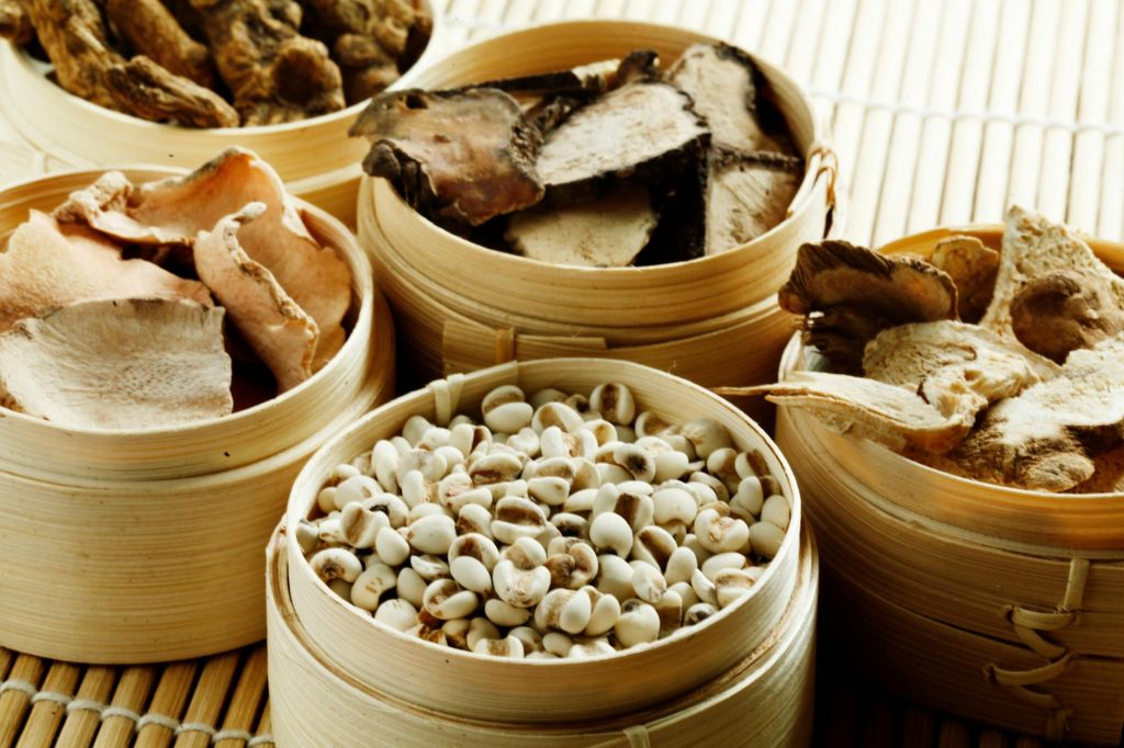 wooden containers with cashew and dried mushrooms